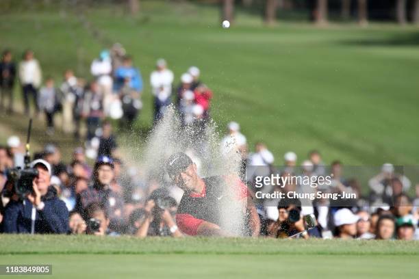 Tiger Woods of the United States hits out from a bunker on the 18th hole during the final round of the Zozo Championship at Accordia Golf Narashino...