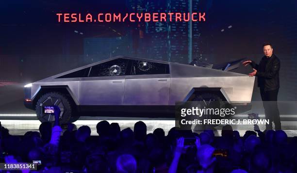 Tesla co-founder and CEO Elon Musk gestures while wrapping up his presentation of the newly unveiled all-electric battery-powered Tesla Cybertruck at...