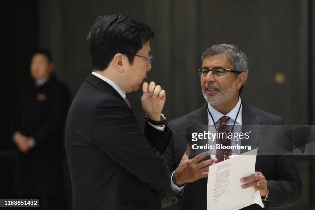 Kai-Fu Lee, chairman and chief executive officer of Sinovation Ventures, left, listens to Sanjay Mehrotra, president and chief executive officer of...