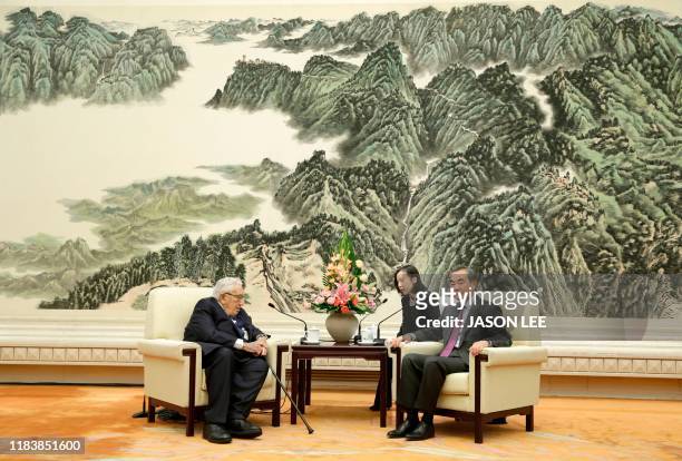 China's Foreign Minister Wang Yi meets with former US Secretary of State Henry Kissinger at the Great Hall of the People in Beijing on November 22,...