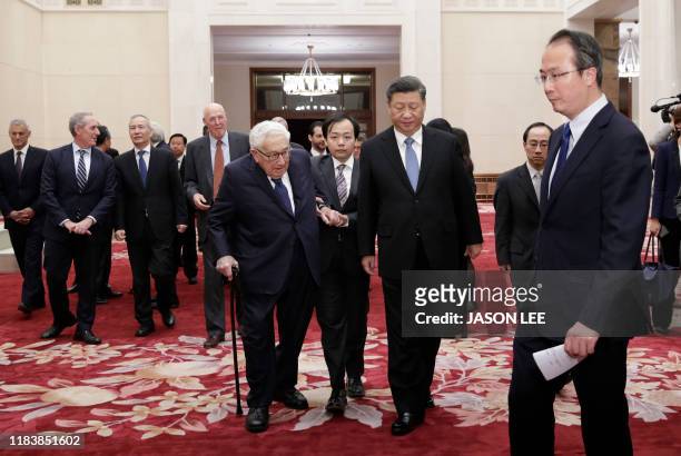 China's President Xi Jinping and former US Secretary of State Henry Kissinger walk to a meeting with delegates from the 2019 New Economy Forum at the...