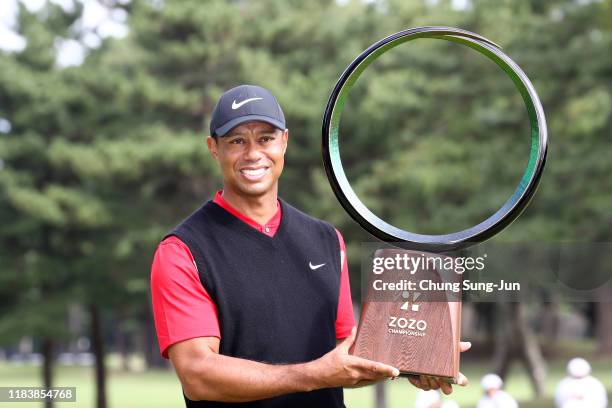 Tiger Woods of the United States poses with the trophy after the award ceremony following the final round of the Zozo Championship at Accordia Golf...