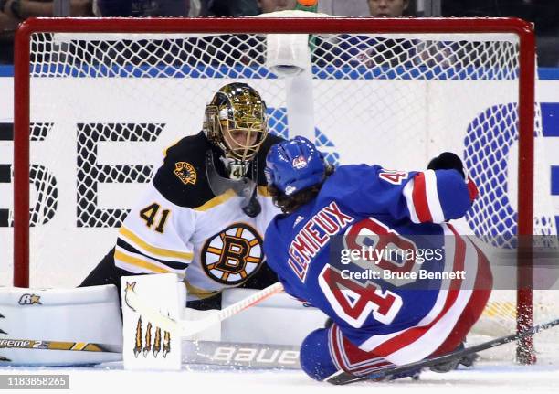 Jaroslav Halak of the Boston Bruins makes the third period chest save on Brendan Lemieux of the New York Rangers at Madison Square Garden on October...