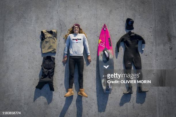 Frances' surfer Justine Dupont poses with her equipment for a big wave surfing session in Nazare, on November 20, 2019. - Nazare host one the two big...
