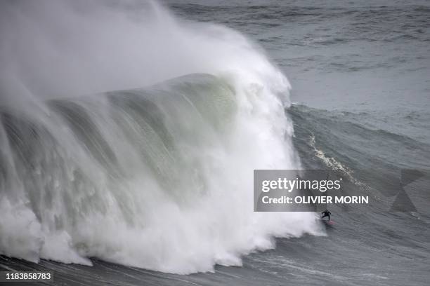 Frances' surfer Justine Dupont rides a big wave during a free surfing session in Nazare, on November 20, 2019. - Nazare host one the two big waves...