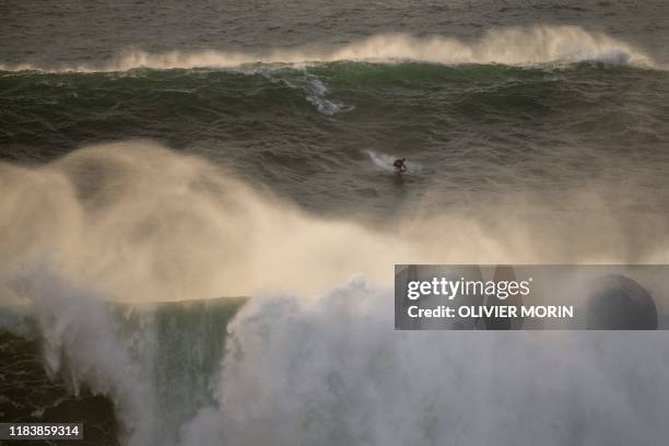 Brazilian surfer Lucas Chumbo rides a wave during a free surfing session in Nazare, on November 20 waves reached between 15 and 20mt high. - Nazare...