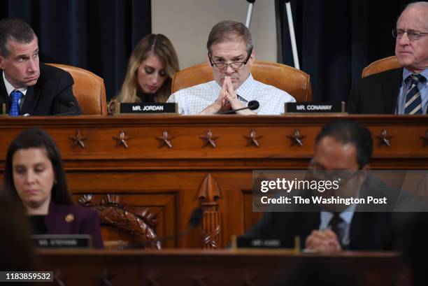 Representative Jim Jordan , center, listens as David A. Holmes, Department of State political counselor for the United States Embassy in Kyiv,...
