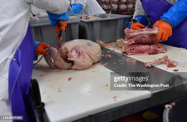 Inmates Todd Radtke, left, and Eric Little, both with their meat cutting certificates, debone turkeys at the Meat Plant within the Maryland...