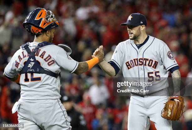 Martin Maldonado and Ryan Pressly of the Houston Astros celebrate their teams 7-1 win against the Washington Nationals in Game Five of the 2019 World...