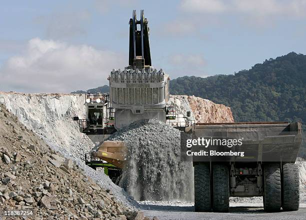 Heavy machinery operates at the Batu Hijau copper and gold mine operated by PT Newmont Nusa Tenggara in Sumbawa, West Nusa Tenggara province,...