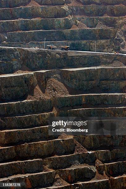 Haul trucks drive through an open pit at the Batu Hijau copper and gold mine operated by PT Newmont Nusa Tenggara in Sumbawa, West Nusa Tenggara...