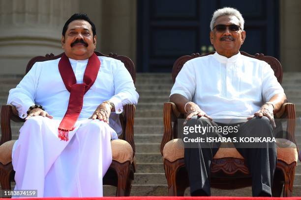 Sri Lanka's new President Gotabaya Rajapaksa and his Prime Minister brother Mahinda Rajapaksa, pose for a group photograph after the ministerial...