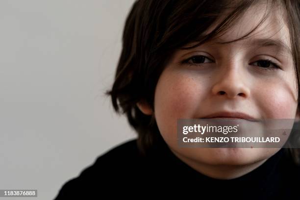 Belgian student Laurent Simons, 9 years old, poses during a photo session at his home on November 21, 2019 in Amsterdam. - Laurent Simons is studying...