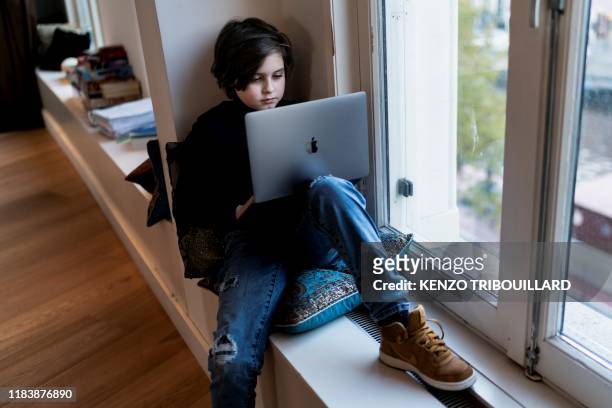 Belgian student Laurent Simons, 9 years old, poses during a photo session at his home on November 21, 2019 in Amsterdam. - Laurent Simons is studying...