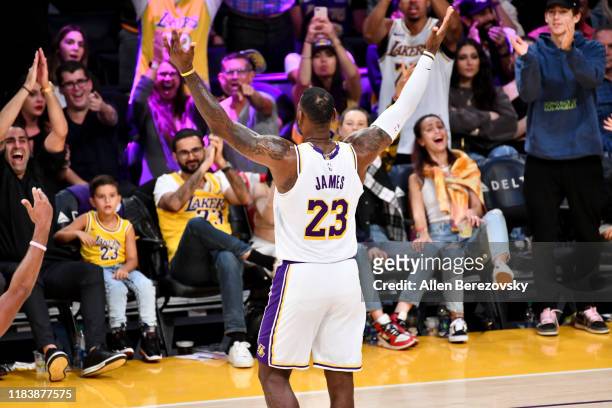 LeBron James celebrates with the fans during a basketball game between the Los Angeles Lakers and the Charlotte Hornets at Staples Center on October...