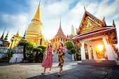 Asian girl walk in Wat phra kaew and grand palace travel in Bangkok city