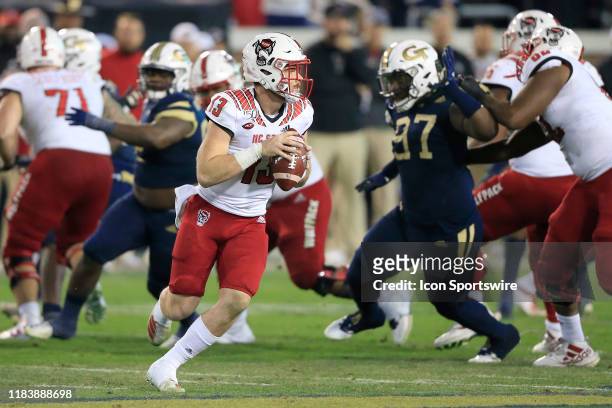 Devin Leary of the North Carolina State Wolfpack rolls out during the college football game between the North Carolina State Wolfpack and the Georgia...
