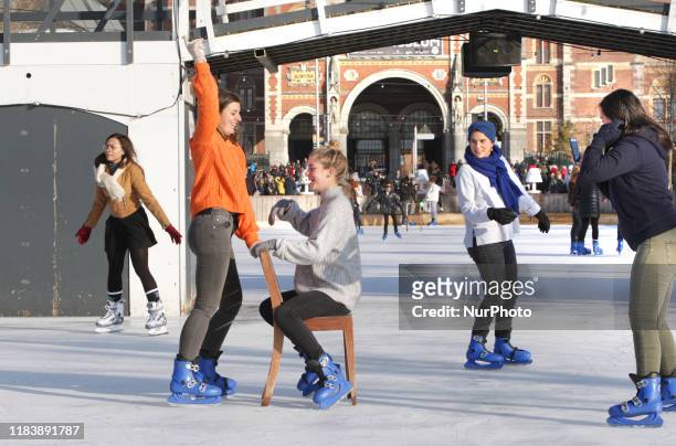 Young girls skating and ejoying on the ice rink in front of the Rijksmuseum in the Museum Square during sunny winter day on November 22, 2019 in...