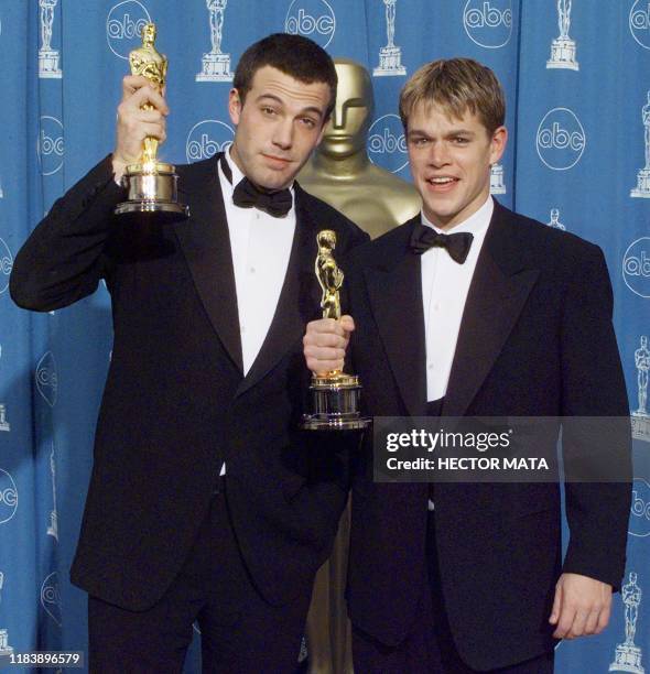 Matt Damon and Ben Affleck pose with their Oscars they won for Best Original Screenplay for "Good Will Hunting" 23 March at the 70th Annual Academy...
