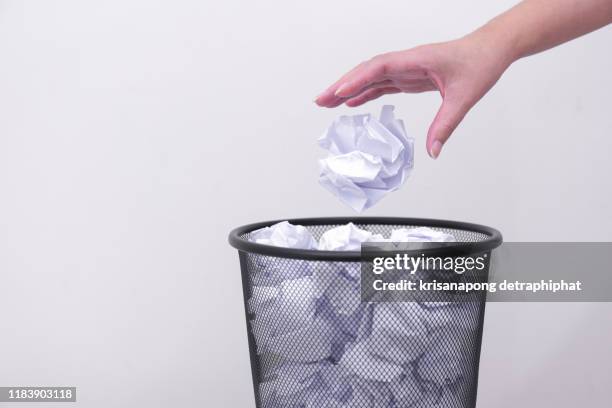 woman hand throwing crumpled paper in basket,littering, trash - wastepaper bin stock pictures, royalty-free photos & images