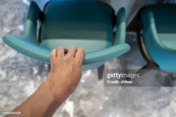 human hand touches the chair back - pulling stock pictures, royalty-free photos & images