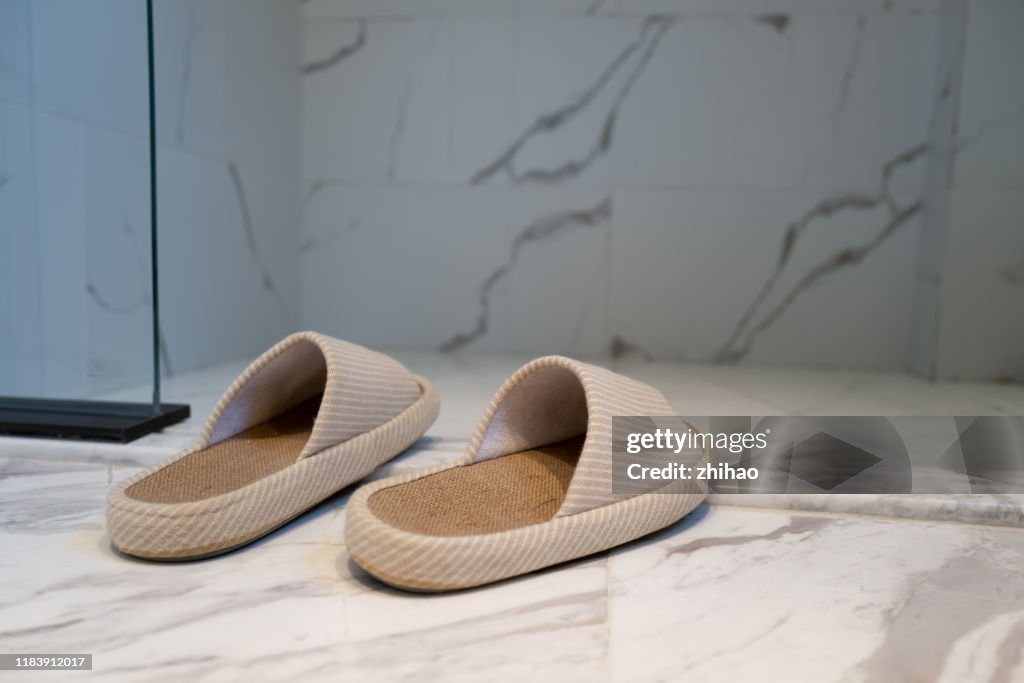 Slippers at the door of the bathroom