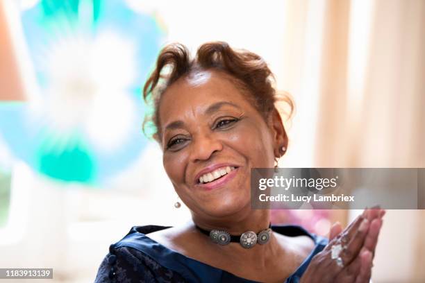 happy woman at a birthday party - older woman birthday stock pictures, royalty-free photos & images