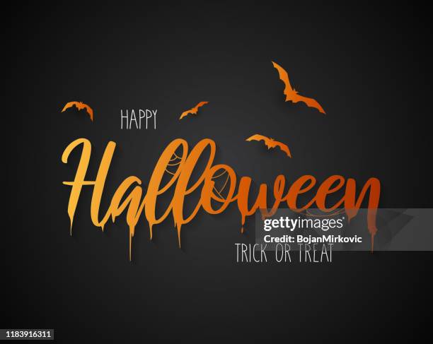 happy halloween lettering with flying bats on black background. vector - fear of writing stock illustrations