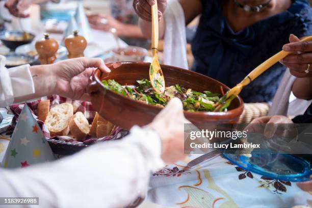 First person view of a woman serving salad at a vegan birthday lunch party