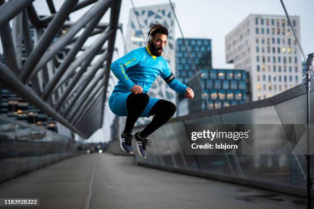 young male adult jumping on the bridge. - oslo train stock pictures, royalty-free photos & images