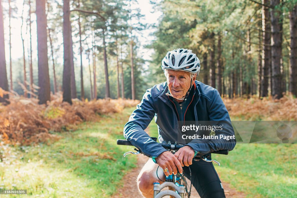Senior male on bike in forest