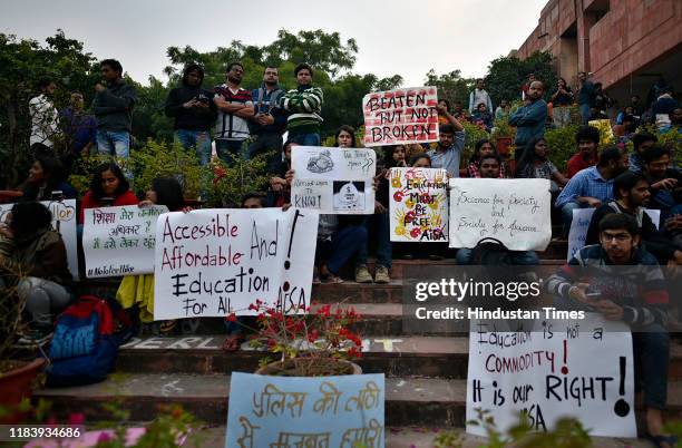 Students hold up placards while protesting at the Admin block against the hostel fee hike and other issues at Jawaharlal Nehru University campus on...