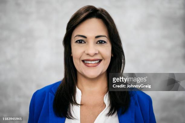 headshot of confident mature latin american businesswoman - blue blazer stock pictures, royalty-free photos & images