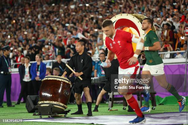 Wales player Dan Biggar takes the pitch as a performer plays a traditional drum before the Rugby World Cup 2019 Semi-Final match between Wales and...