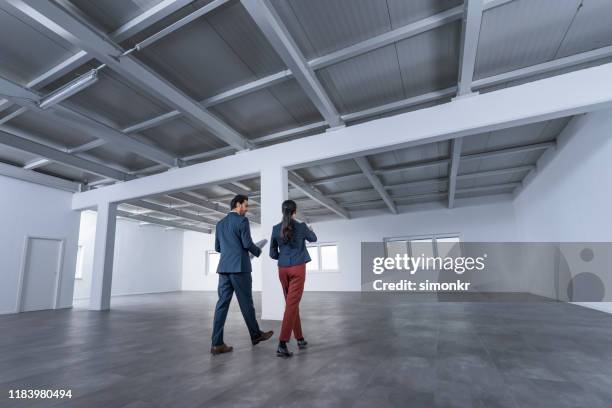 business people discussing blueprint - floor walk business stock pictures, royalty-free photos & images