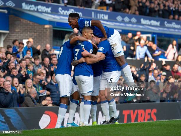 Everton players celebrate with goalscorer Bernard during the Premier League match between Everton FC and West Ham United at Goodison Park on October...