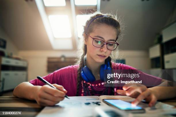 teenage girl doing homework - cell phones in school stock pictures, royalty-free photos & images