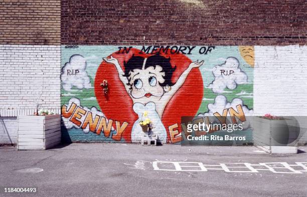 View of a sidewalk mural, 'In Memory of Jenny and Evelyn' , New York, New York, 1990. It features a illustration of the cartoon character Betty Boop,...