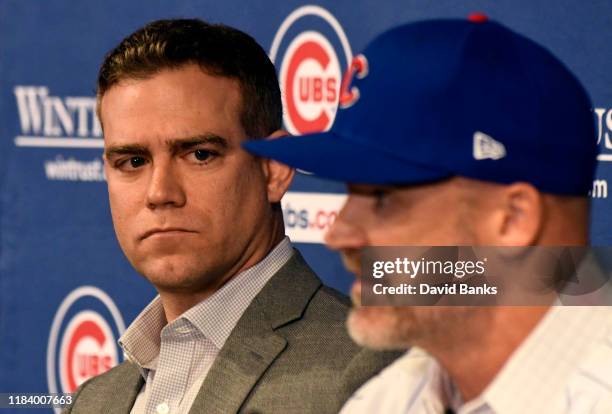 Theo Epstein, president of baseball operations of the Chicago Cubs, looks on as David Ross, new manager of the Cubs talks to the media during a press...