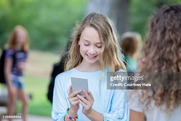 pre teen girl textning på hennes telefon - pre adolescent child bildbanksfoton och bilder