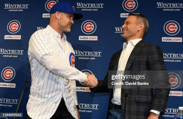 David Ross, new manager of the Chicago Cubs and Jed Hoyer, general manager of the Cubs, shake hands as Ross is introduced to the media at Wrigley...