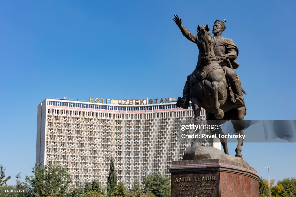 Amir Temur statue on the square baring his name with Hotel Uzbekistan in the background, Tashkent