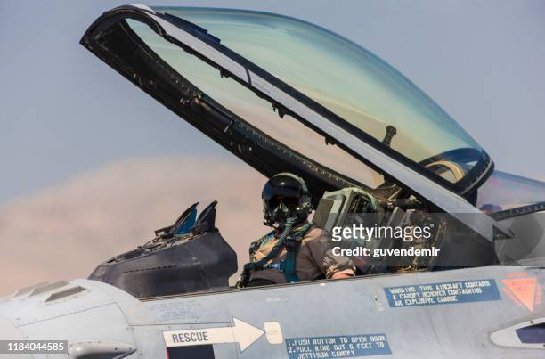 pilot in the cocpit of an f-16 fighter jet plane. - pilot stock pictures, royalty-free photos & images
