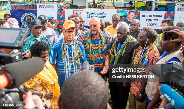 Bougainville regional president John Momis speaks to the media before casting his ballot in an historical independence vote as the Papua New Guinea...