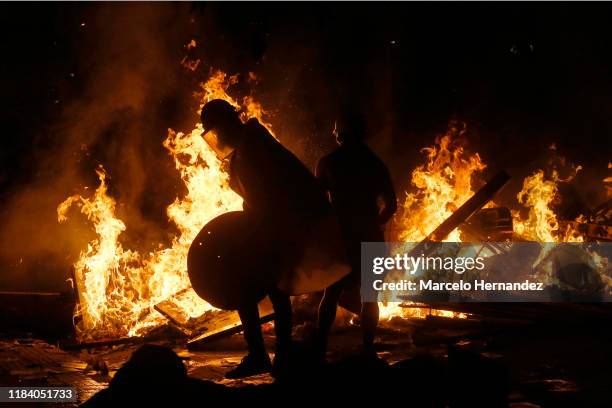 Demonstrators burn a barricade during protests against the government of President Sebastian Piñera and longstanding inequality on November 22, 2019...