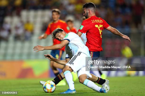 Exequiel Zeballos of Argentina trips over Jose David Menargues of Spain during the FIFA U-17 World Cup Brazil 2019 group E match between Spain and...