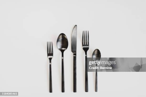 black cutlery on a white background - カトラリー ストックフォトと画像