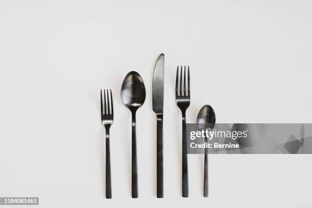 black cutlery on a white background - acabamento mate imagens e fotografias de stock