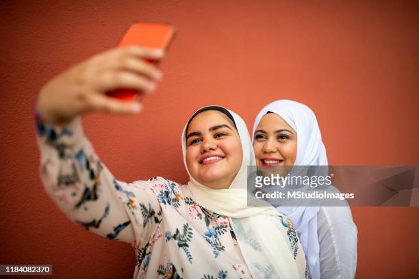 making a selfie - chubby arab stock pictures, royalty-free photos & images
