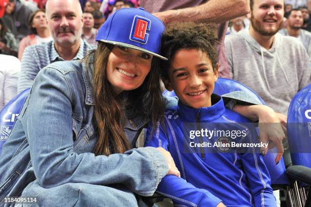 Idina Menzel and Walker Nathaniel Diggs attend a basketball game between the Los Angeles Clippers and the Charlotte Hornets at Staples Center on...